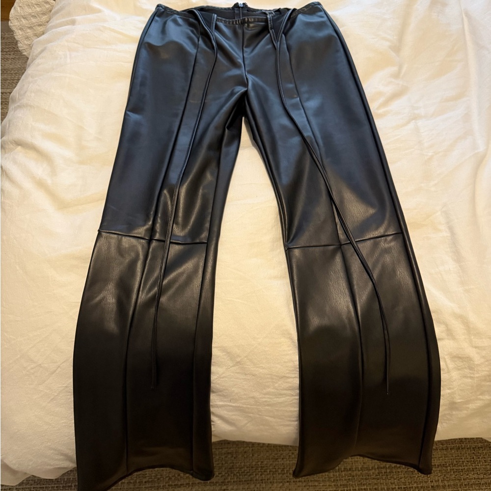 Medium black leather pants with a waist tie.